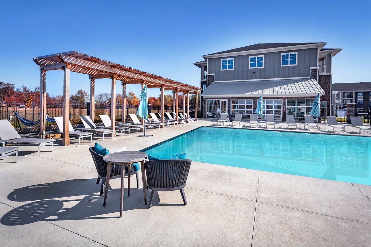 Salt water pool with lounge seating and pergola at Flats at Stones Crossing